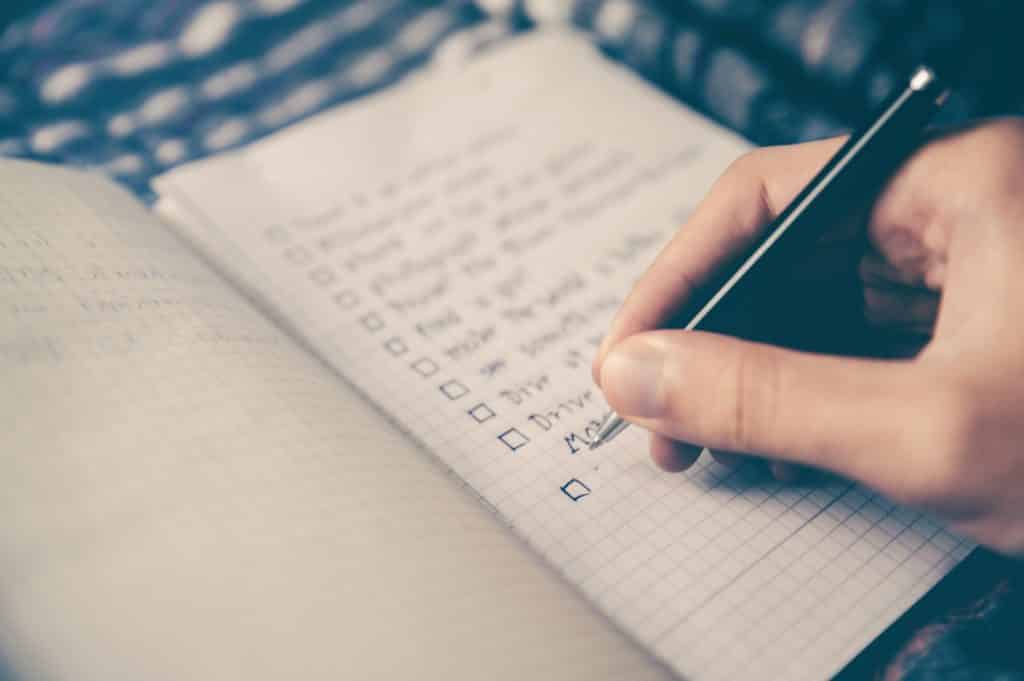 written checklist in notebook