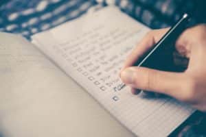 written checklist in notebook