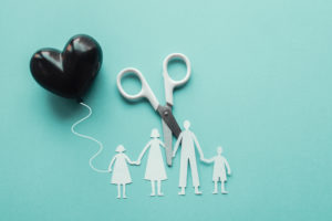 scissors cutting family paper cut out holding black heart