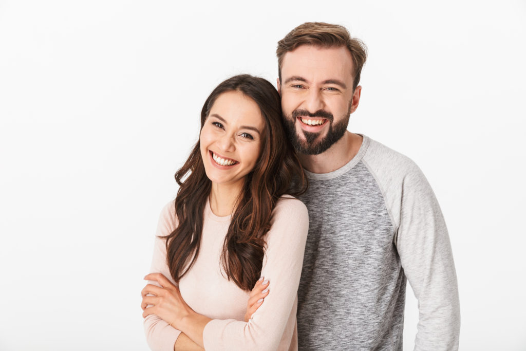 smiling young couple looking camera
